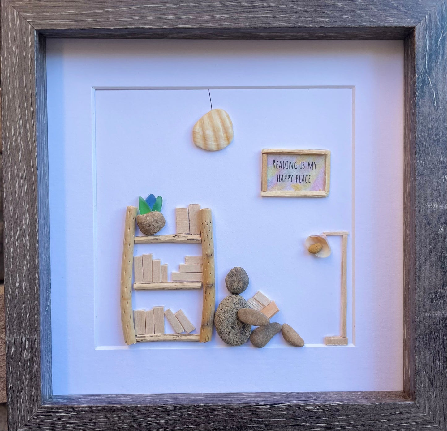 Unique Gift for Book Lovers, 8x8 Pebble Art Picture of Reader Surrounded by Books, Wall Sign Says "Reading is My Happy Place"