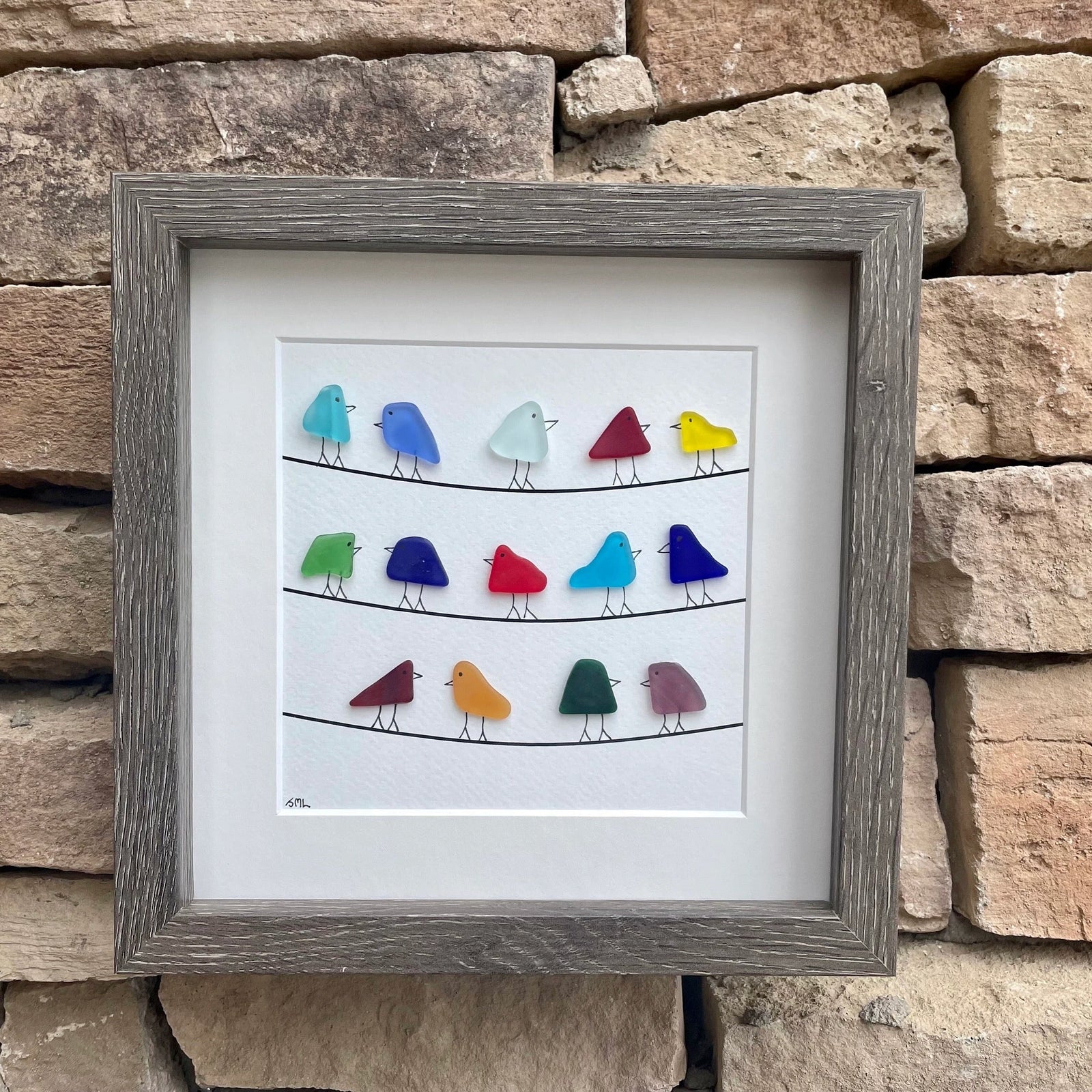 Picture of sea glass birds on power lines