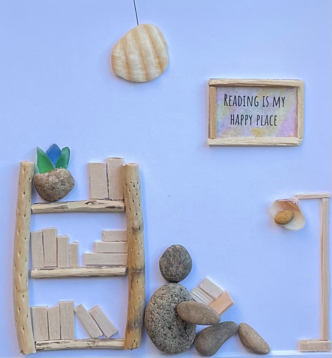 Unique Gift for Book Lovers, 8x8 Pebble Art Picture of Reader Surrounded by Books, Wall Sign Says "Reading is My Happy Place"