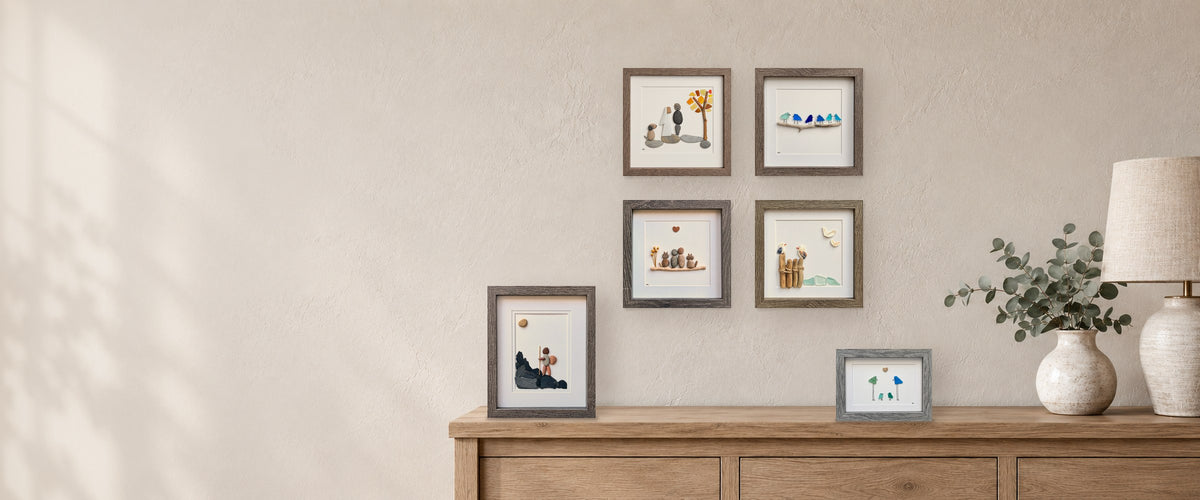 Sea glass and pebble art displayed on a wall and sideboard